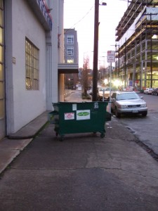 Dumpster on sidewalk